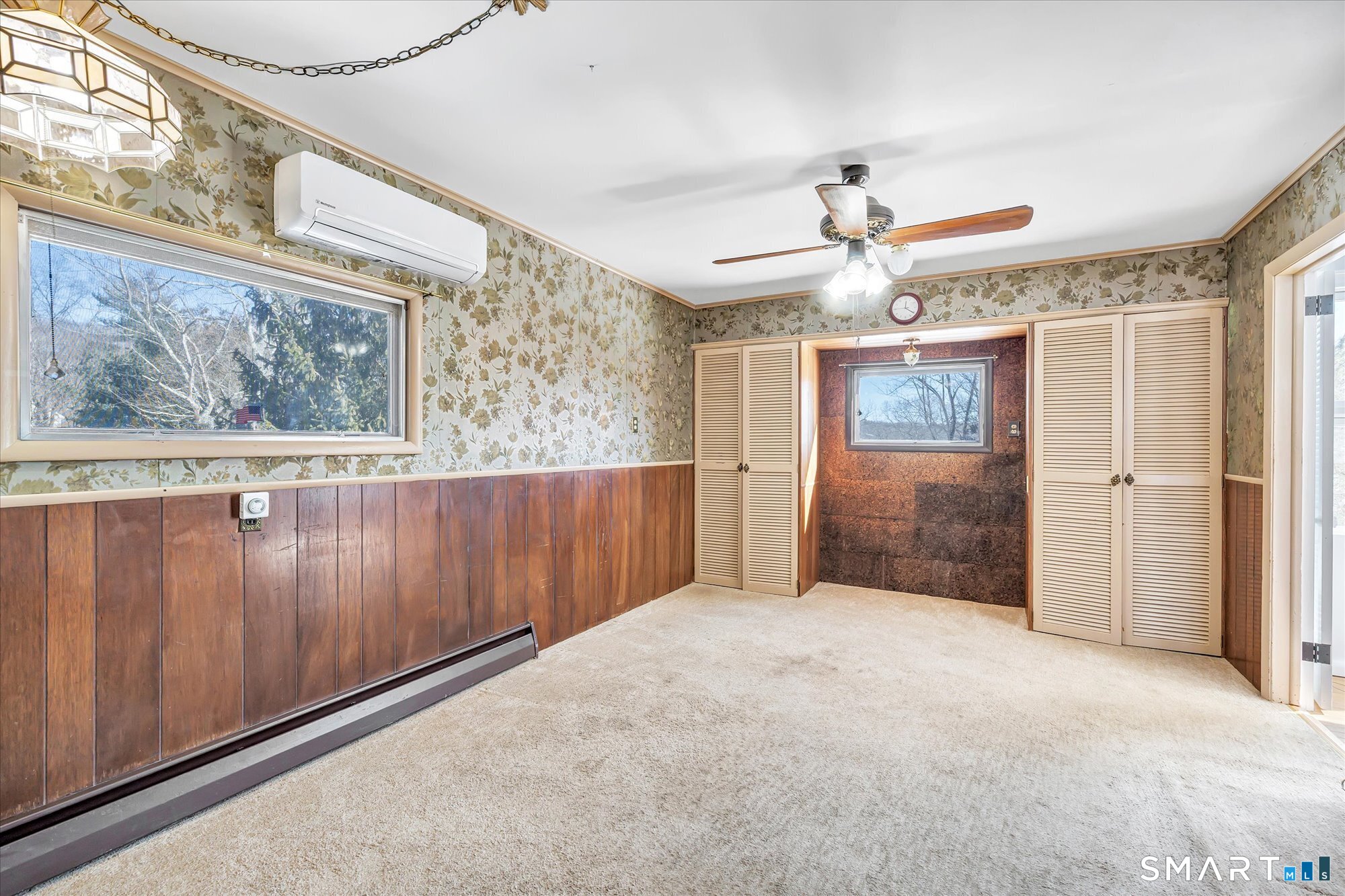 61 Soundview Avenue Shelton, CT 06484 - Photo 8 of 33 a view of a hallway with a chandelier fan and wooden floor