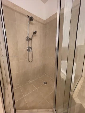 a bathroom with a glass door shower