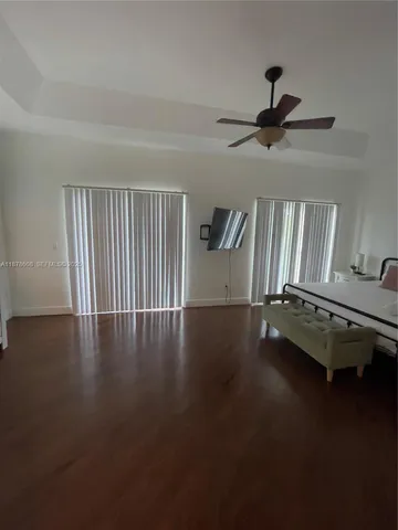 a living room with furniture and a ceiling fan