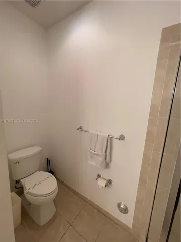 a white toilet sitting next to a sink