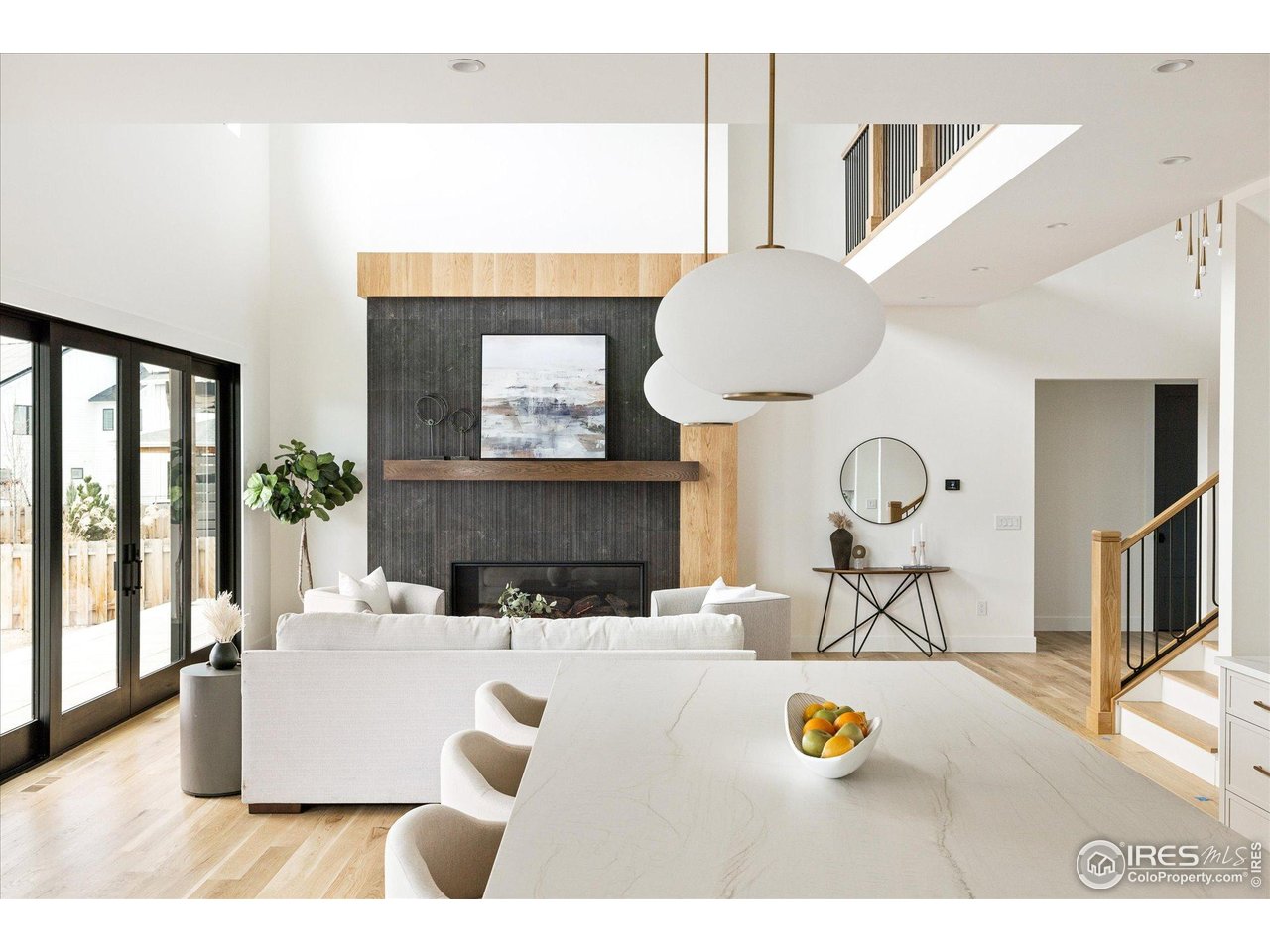 848 Trail Ridge Drive Louisville, CO 80027 - Photo 15 of 48 a living room with furniture a mirror and a fireplace