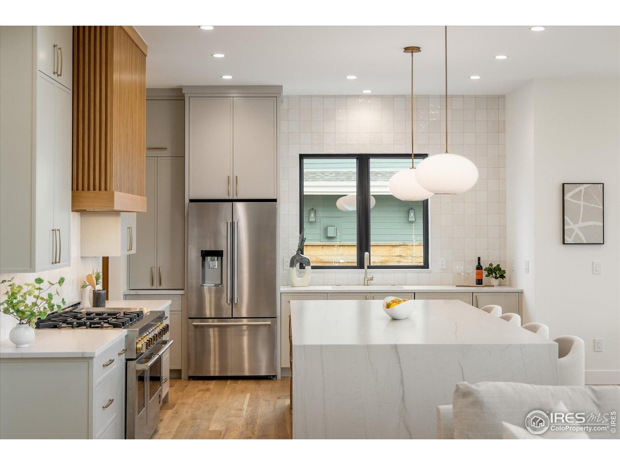 848 Trail Ridge Drive Louisville, CO 80027 - Photo 16 of 48 a kitchen with kitchen island a large counter top space appliances and cabinets