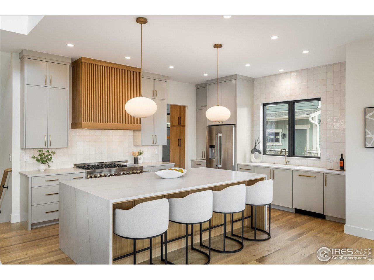 848 Trail Ridge Drive Louisville, CO 80027 - Photo 17 of 48 a kitchen with kitchen island granite countertop a table and chairs in it