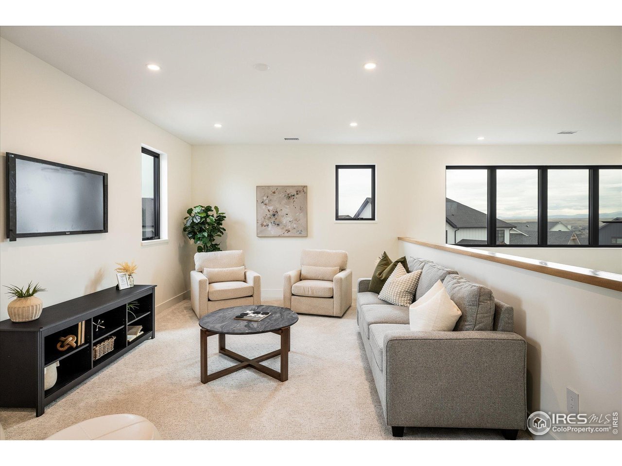 848 Trail Ridge Drive Louisville, CO 80027 - Photo 31 of 48 a living room with furniture and a flat screen tv