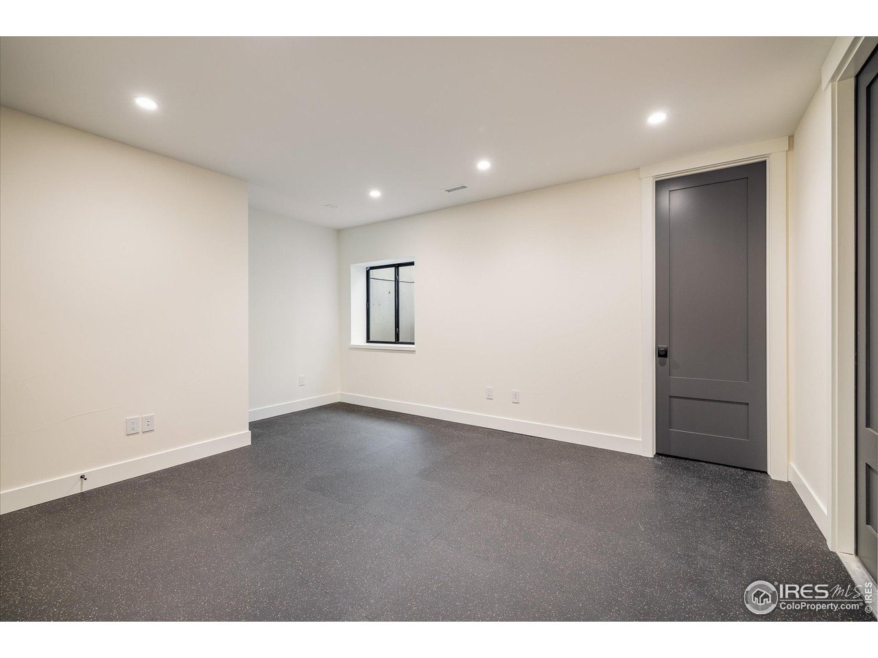 848 Trail Ridge Drive Louisville, CO 80027 - Photo 44 of 48 a view of an empty room with wooden floor and a window