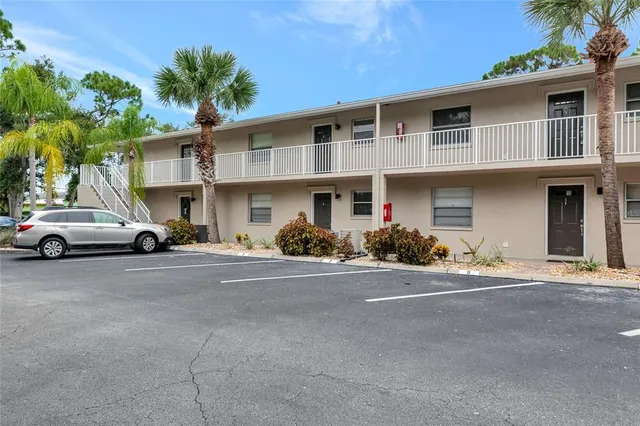 a couple of cars parked in front of a house