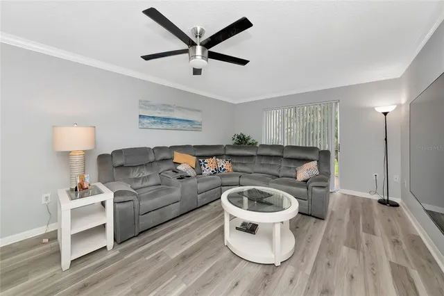a living room with furniture a rug and a chandelier