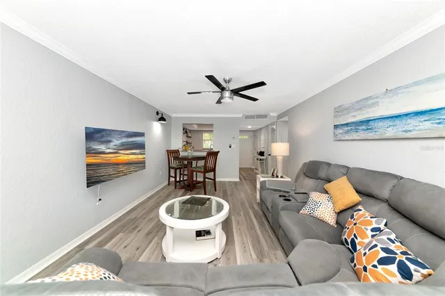 a living room with furniture a rug and a wall painting