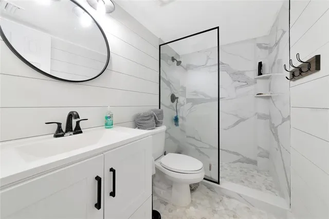 a bathroom with a sink a toilet and a mirror