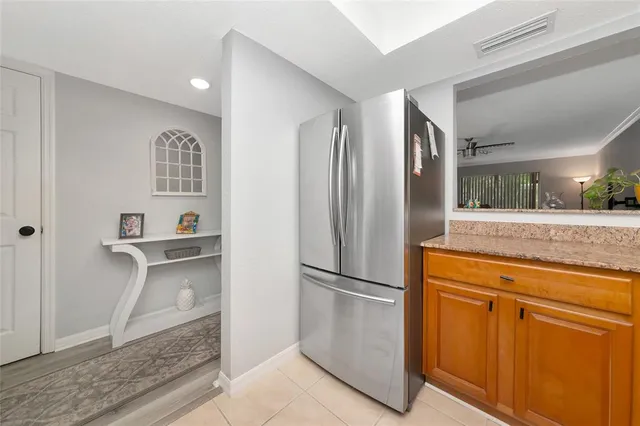 a kitchen with stainless steel appliances granite countertop a refrigerator and a sink
