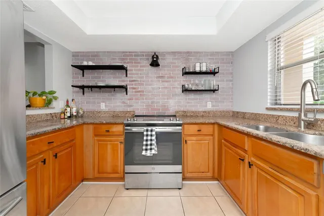 a kitchen with stainless steel appliances granite countertop a sink and cabinets