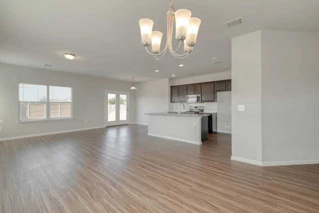 a view of a kitchen with an empty space and a window