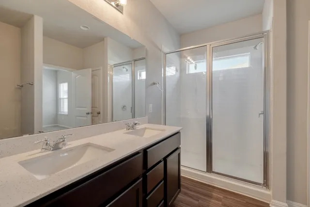 a bathroom with a double vanity sink and a mirror