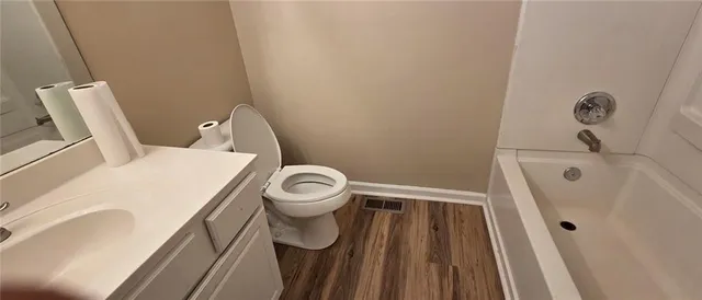a white toilet sitting next to a sink