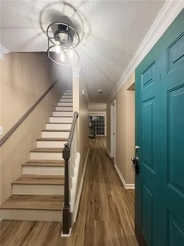 a view of entryway and hall with wooden floor