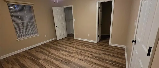 a view of a room with wooden floor and window