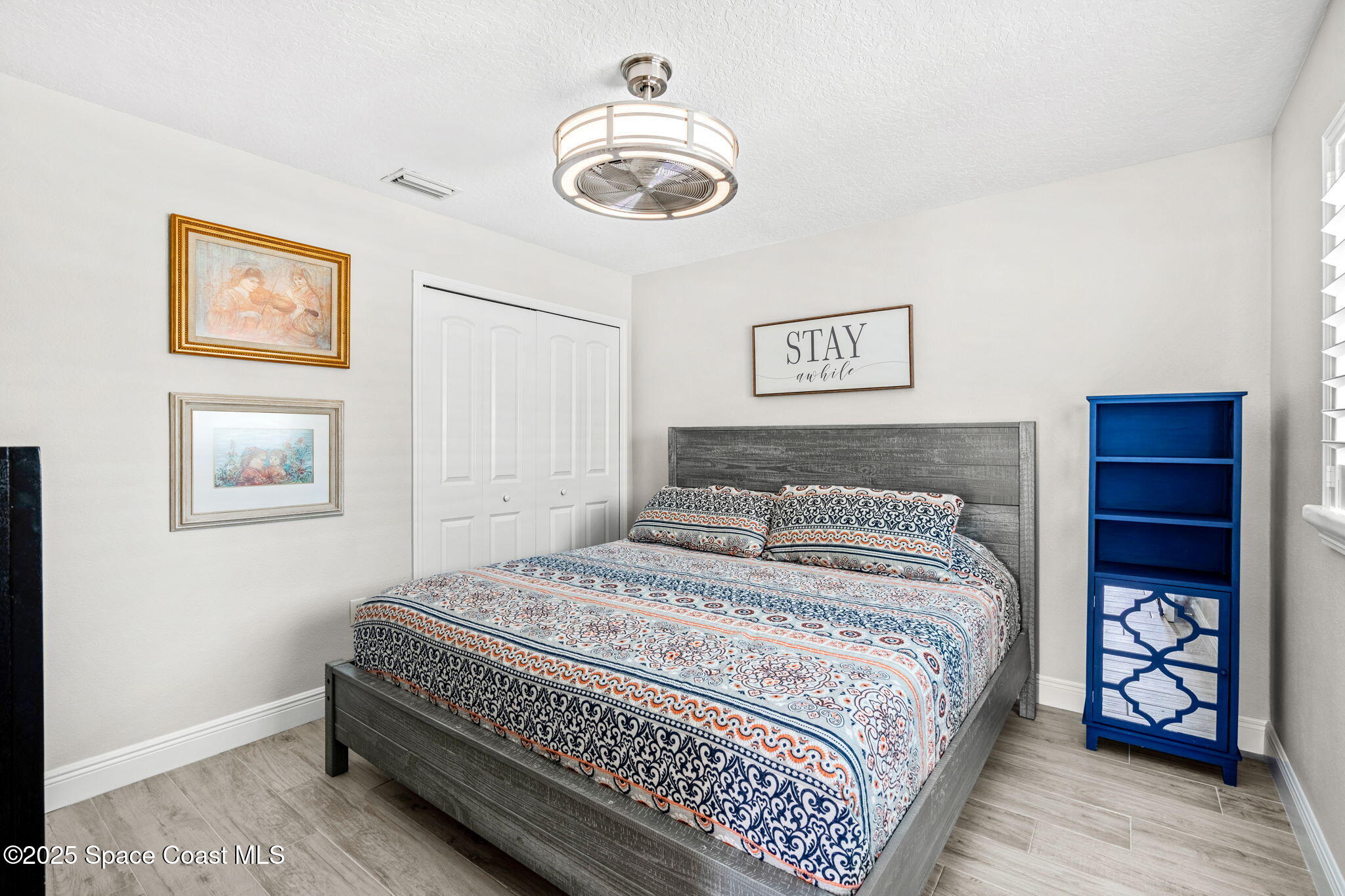 4440 Chardonnay Drive Rockledge, FL 32955 - Photo 13 of 41 a bedroom with a bed and a lamp