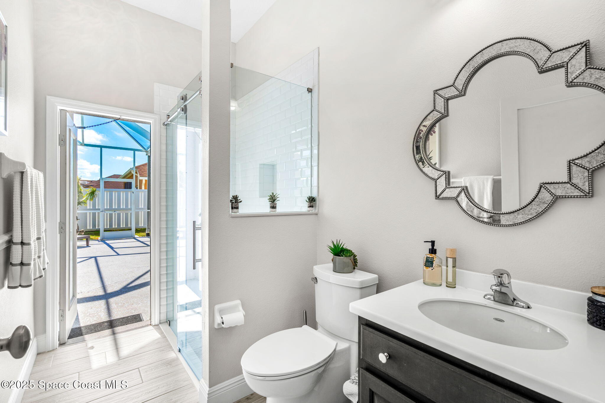 4440 Chardonnay Drive Rockledge, FL 32955 - Photo 14 of 41 a bathroom with a sink a toilet and a mirror