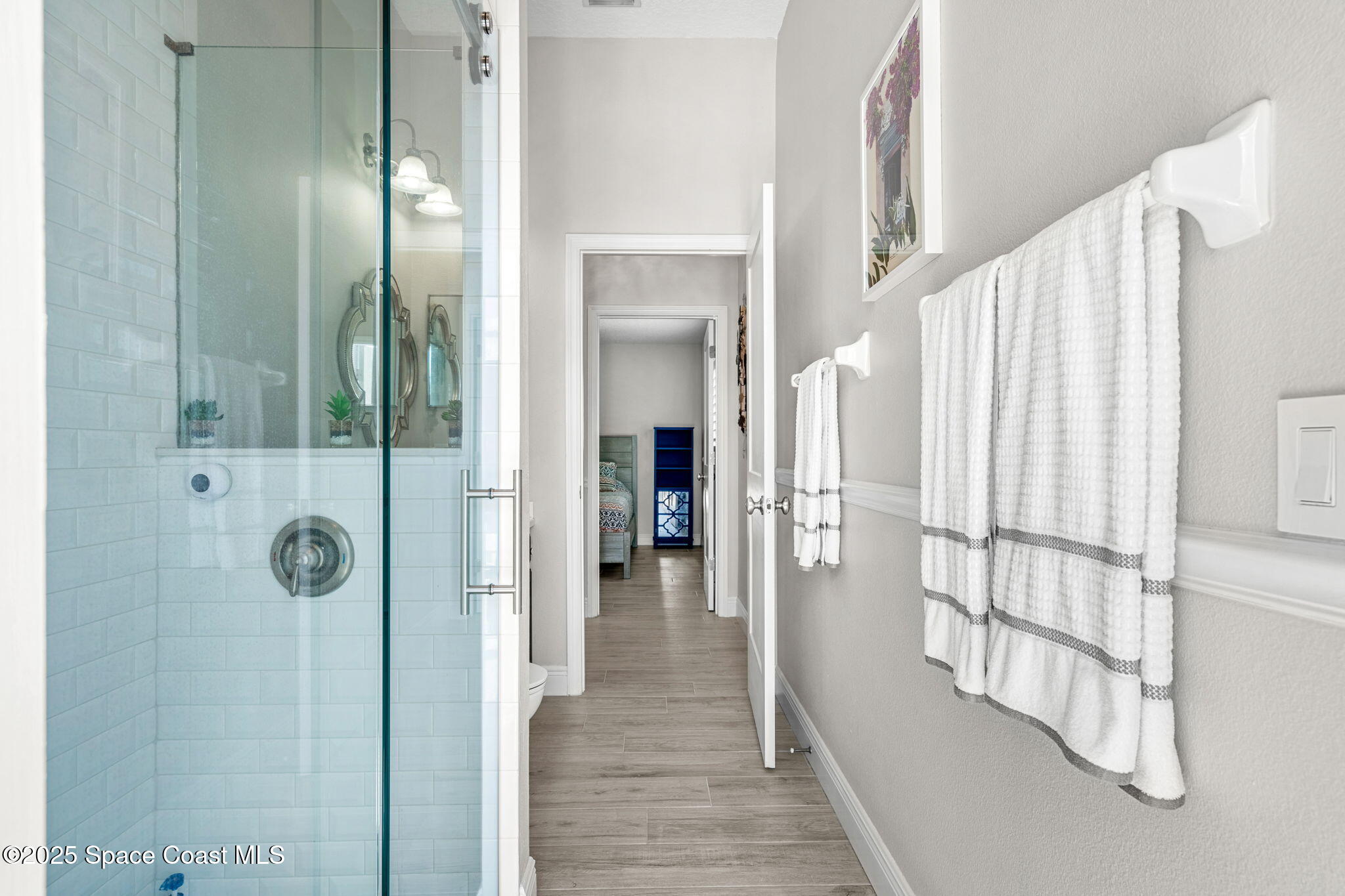 4440 Chardonnay Drive Rockledge, FL 32955 - Photo 15 of 41 a view of a hallway with wooden floor and staircase