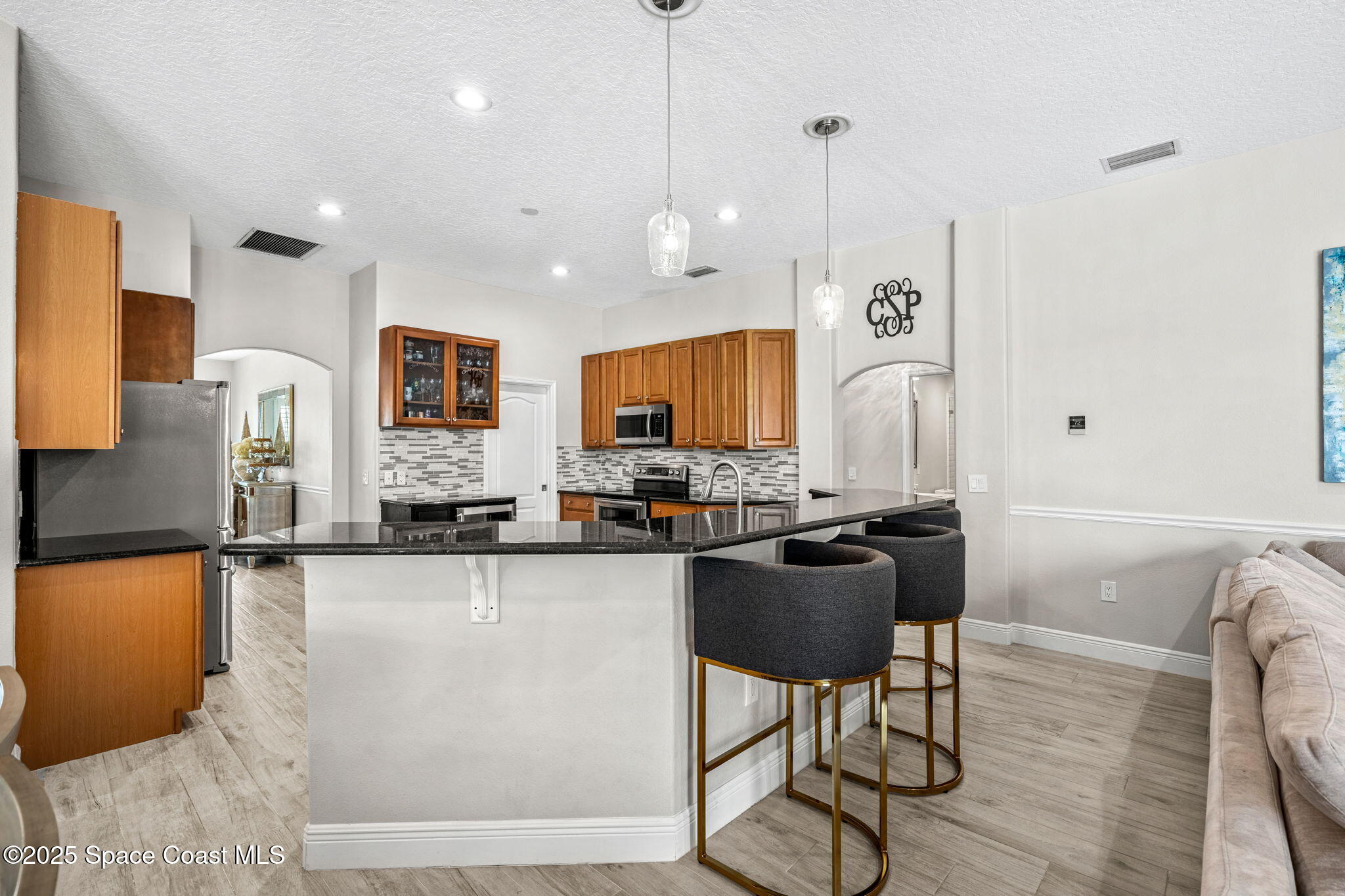 4440 Chardonnay Drive Rockledge, FL 32955 - Photo 17 of 41 a kitchen with sink refrigerator and cabinets