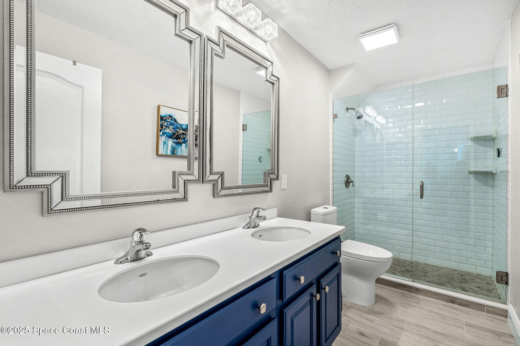 4440 Chardonnay Drive Rockledge, FL 32955 - Photo 18 of 41 a bathroom with a sink double vanity granite toilet and shower