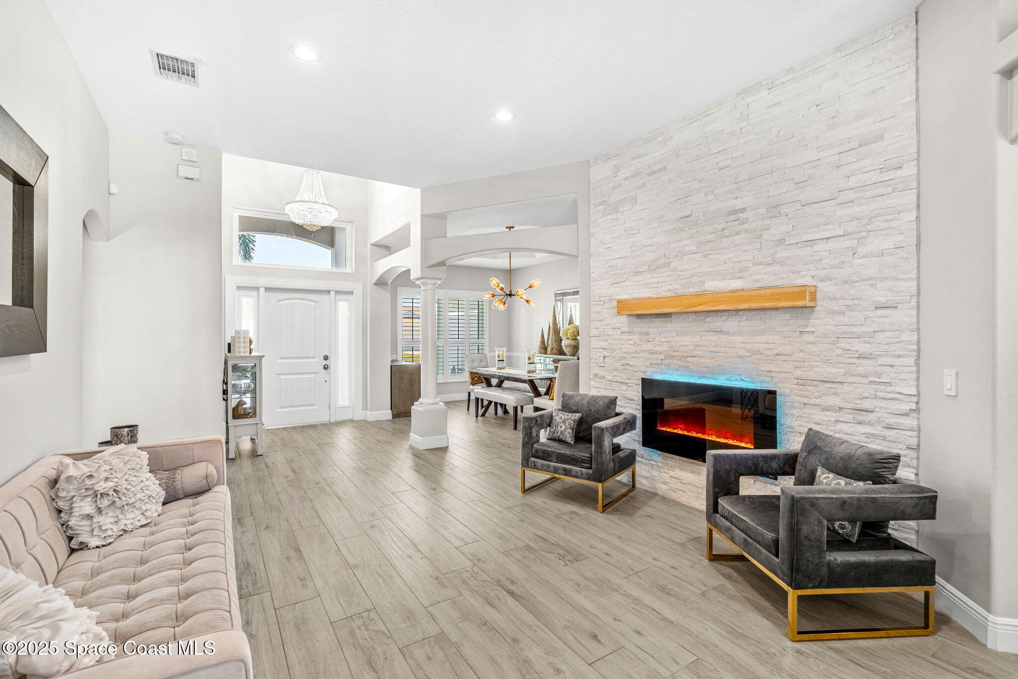 4440 Chardonnay Drive Rockledge, FL 32955 - Photo 25 of 41 a living room with furniture and a fireplace