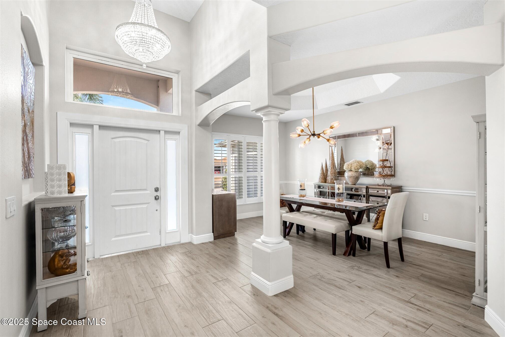 4440 Chardonnay Drive Rockledge, FL 32955 - Photo 3 of 41 a view of a dining room with furniture and wooden floor