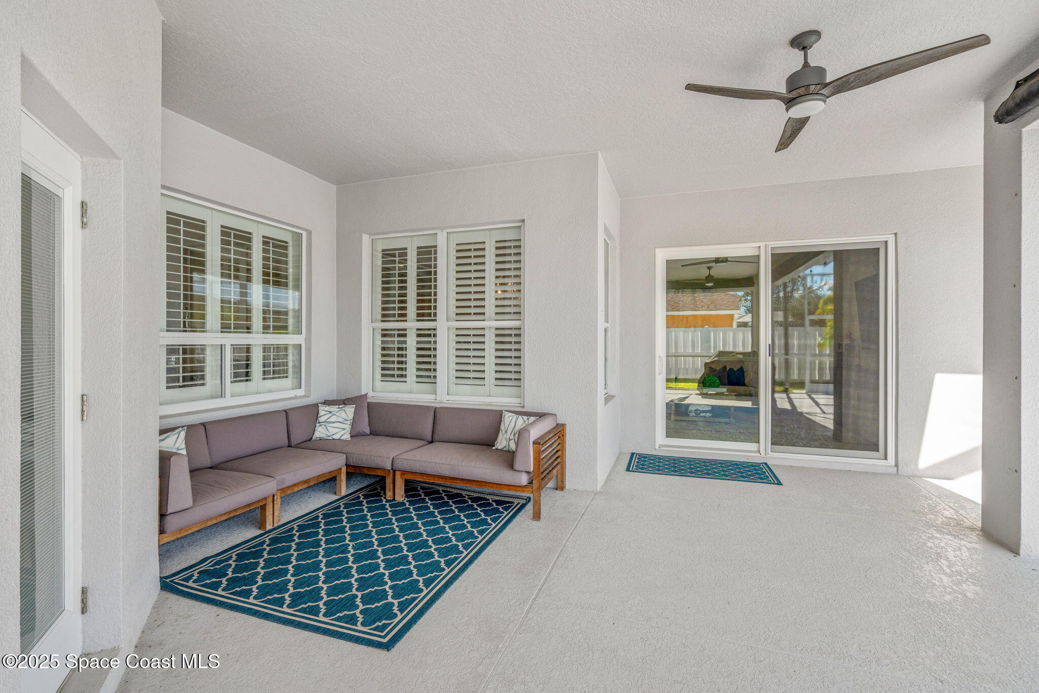 4440 Chardonnay Drive Rockledge, FL 32955 - Photo 33 of 41 a living room with furniture and a floor to ceiling window