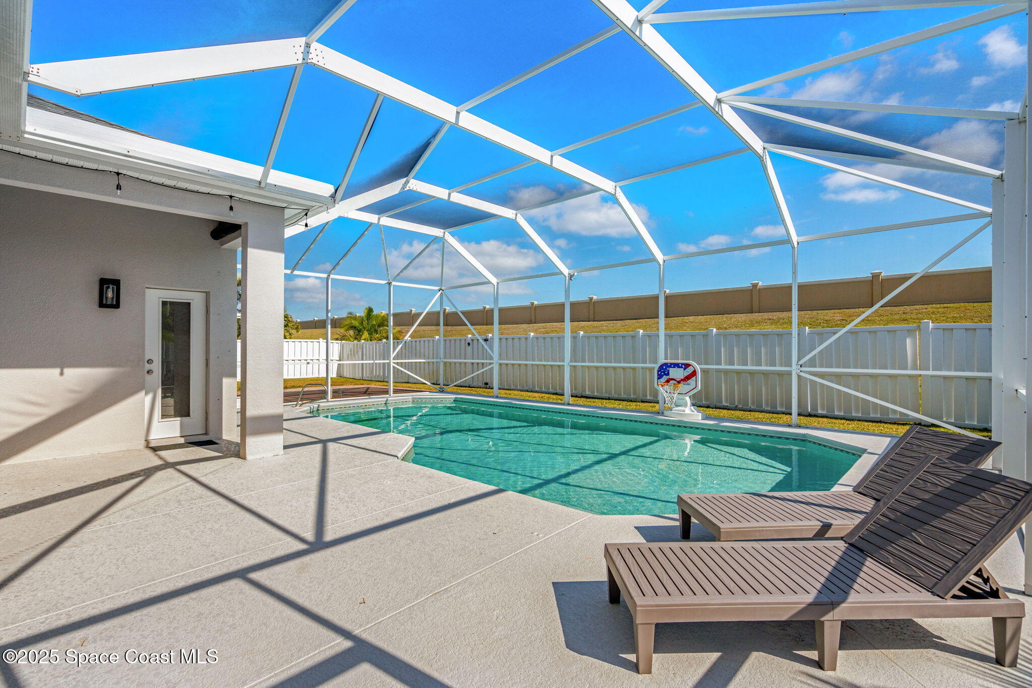 4440 Chardonnay Drive Rockledge, FL 32955 - Photo 34 of 41 a view of a backyard with table and chairs under an umbrella