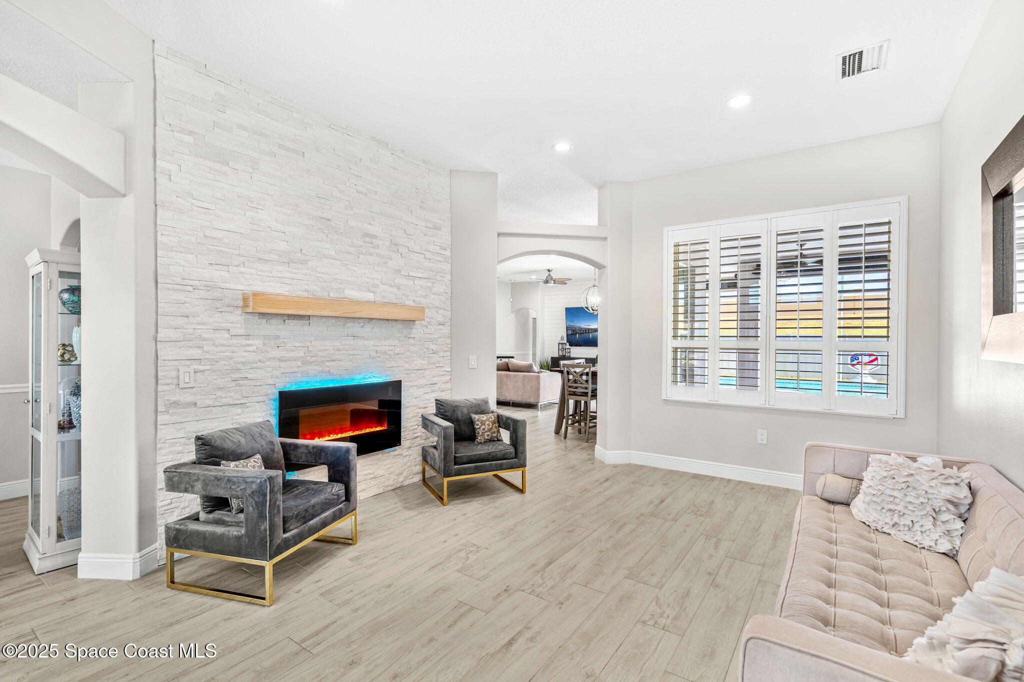 4440 Chardonnay Drive Rockledge, FL 32955 - Photo 7 of 41 a living room with furniture and a fireplace