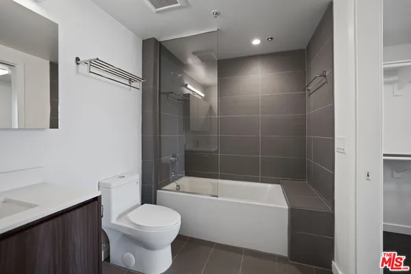 a bathroom with a bathtub toilet and a shower