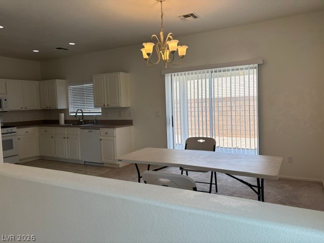 2866 Shimmering Bay Street Laughlin, NV 89029 - Photo 8 of 32 The combined kitchen and dining area features abundant cabinetry and a bright sliding glass door leading to the yard.
