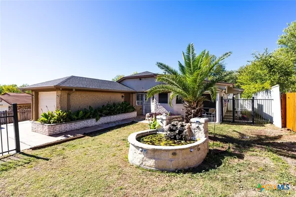 a front view of a house with swimming pool and furniture