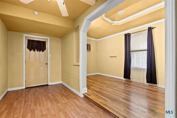 a view of a hallway with wooden floor and closet