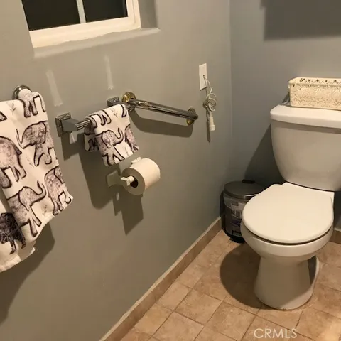 a bathroom with a toilet and a mirror
