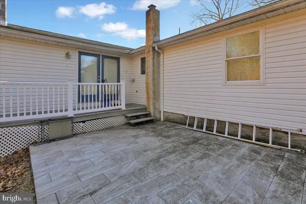 a backyard of a house with table and chairs