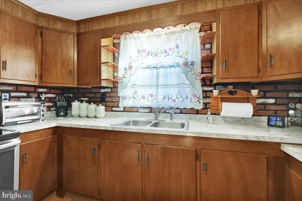 a kitchen with stainless steel appliances granite countertop a sink a stove and cabinets