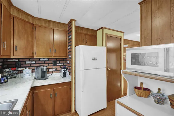 a kitchen with a refrigerator and cabinets
