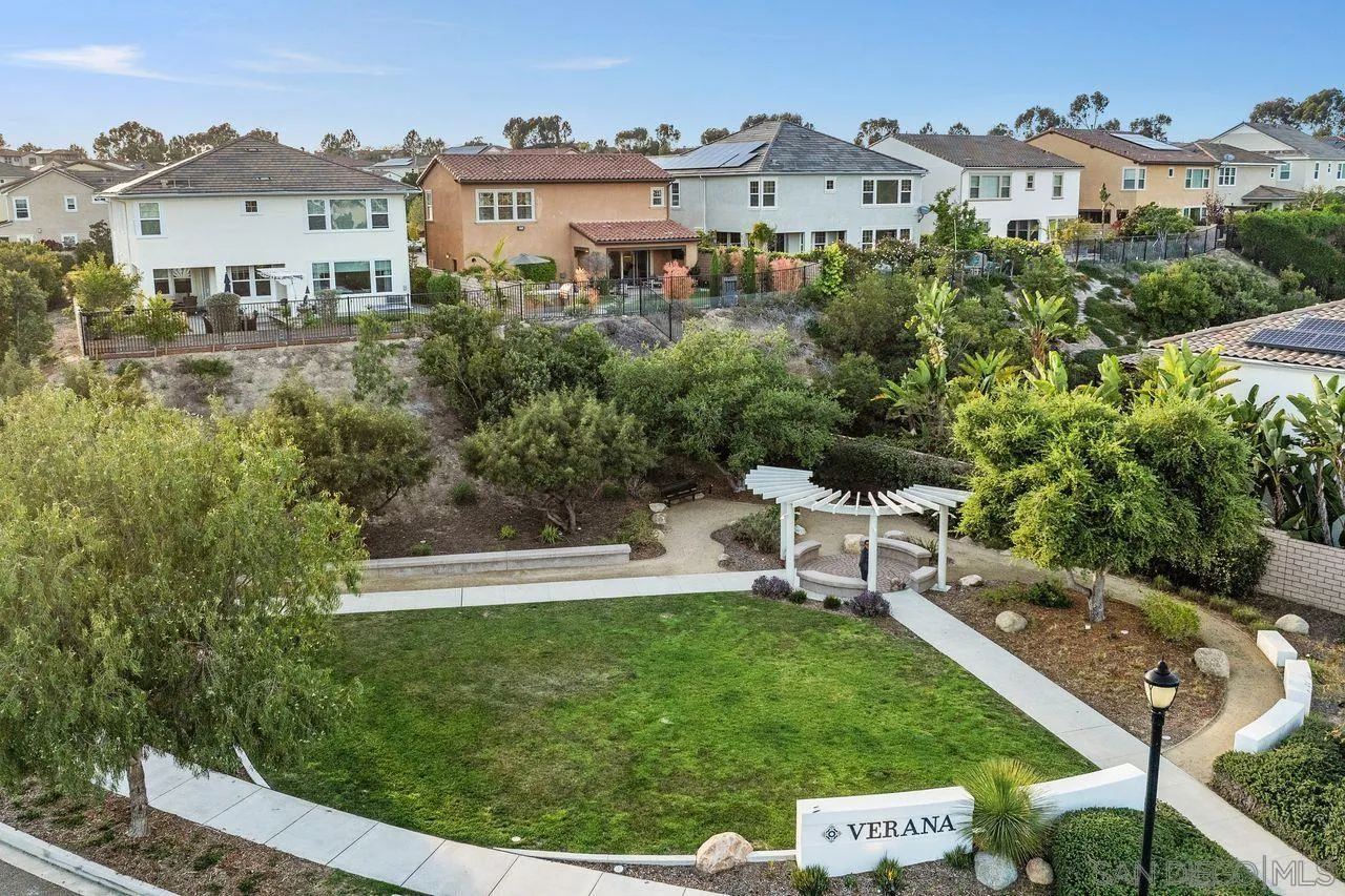 13509 Cielo Ranch Road San Diego, CA 92130 - Photo 13 of 54 a view of a white house with a big yard and potted plants