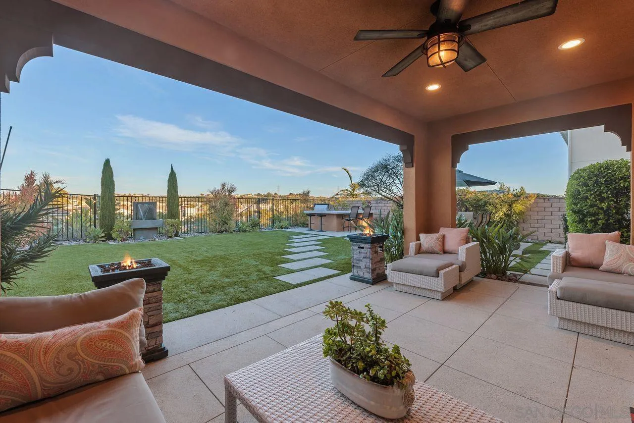 13509 Cielo Ranch Road San Diego, CA 92130 - Photo 14 of 54 a living room with patio furniture and a garden