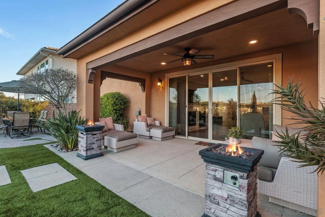13509 Cielo Ranch Road San Diego, CA 92130 - Photo 15 of 54 a view of a patio with couches and table and chairs and potted plants