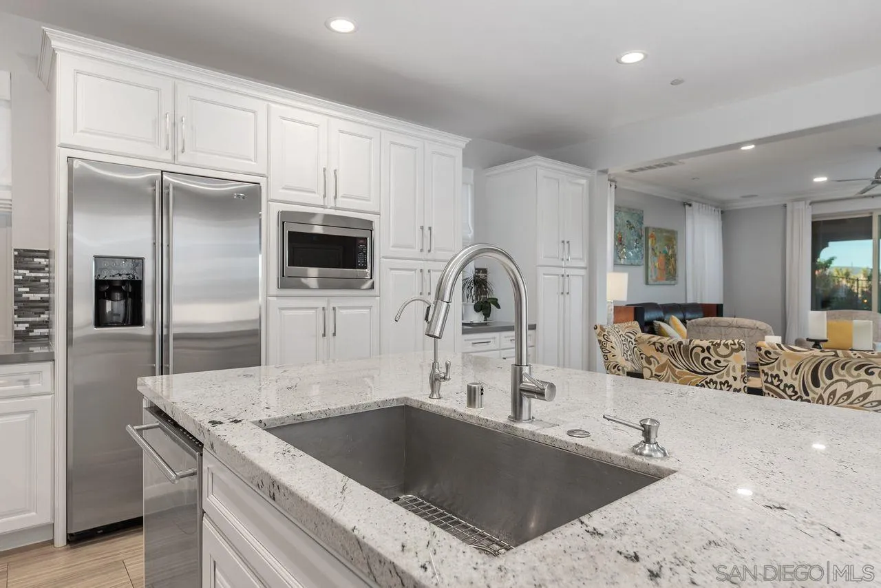 13509 Cielo Ranch Road San Diego, CA 92130 - Photo 24 of 54 a kitchen with stainless steel appliances granite countertop a sink and a refrigerator