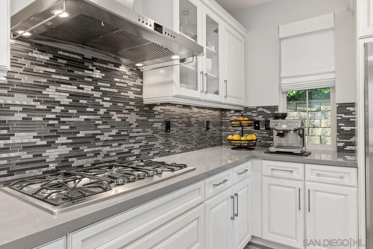 13509 Cielo Ranch Road San Diego, CA 92130 - Photo 25 of 54 a kitchen with stainless steel appliances granite countertop a sink stove and cabinets