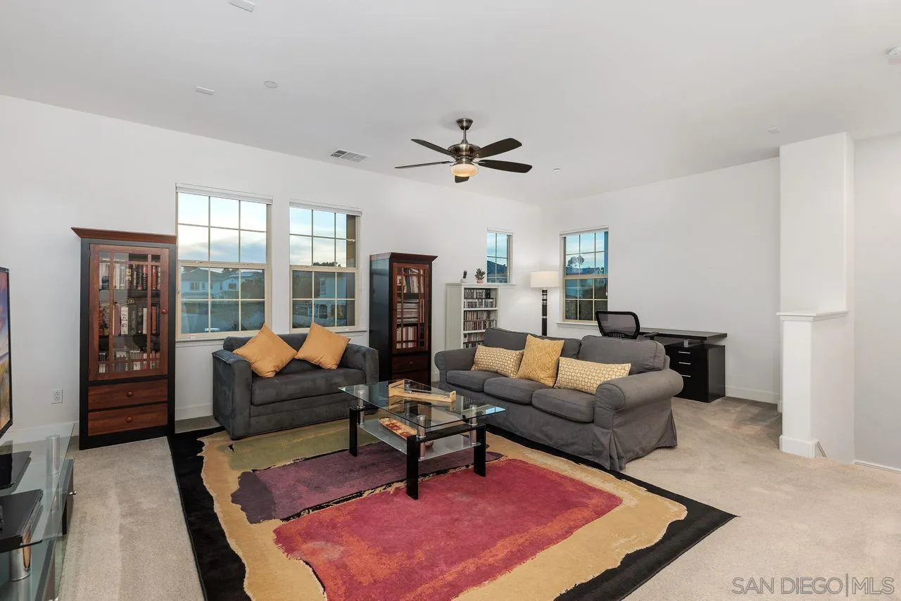 13509 Cielo Ranch Road San Diego, CA 92130 - Photo 28 of 54 a living room with furniture a rug and a large window