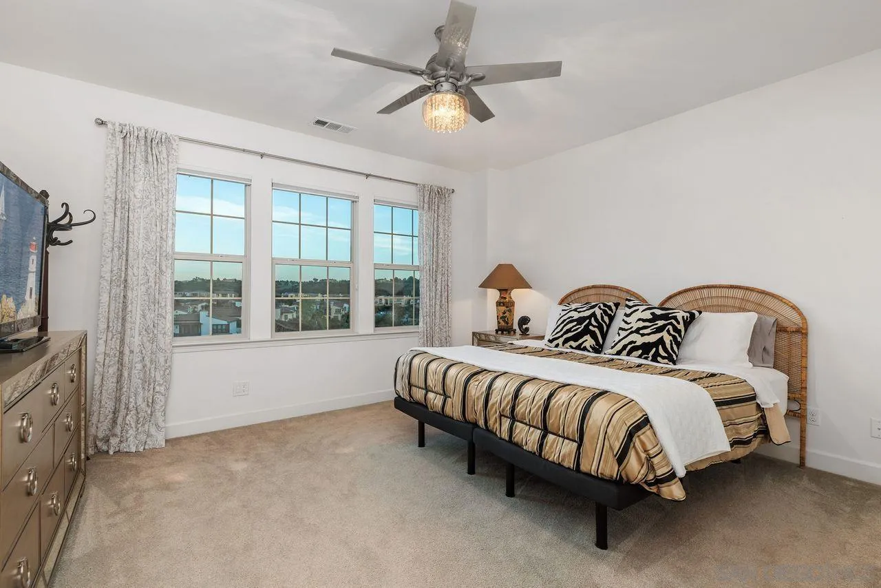 13509 Cielo Ranch Road San Diego, CA 92130 - Photo 30 of 54 a spacious bedroom with a bed and a flat screen tv