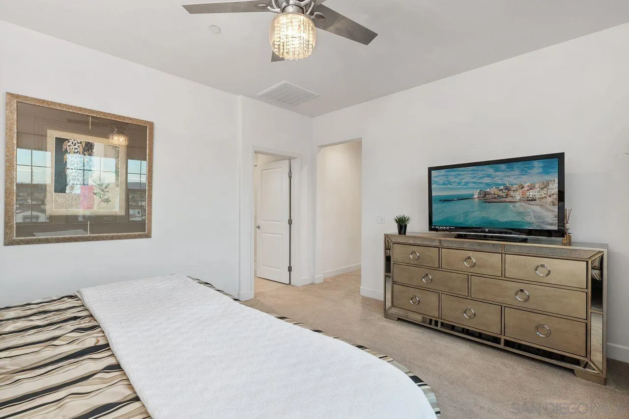 13509 Cielo Ranch Road San Diego, CA 92130 - Photo 31 of 54 a bedroom with a bed and a flat screen tv