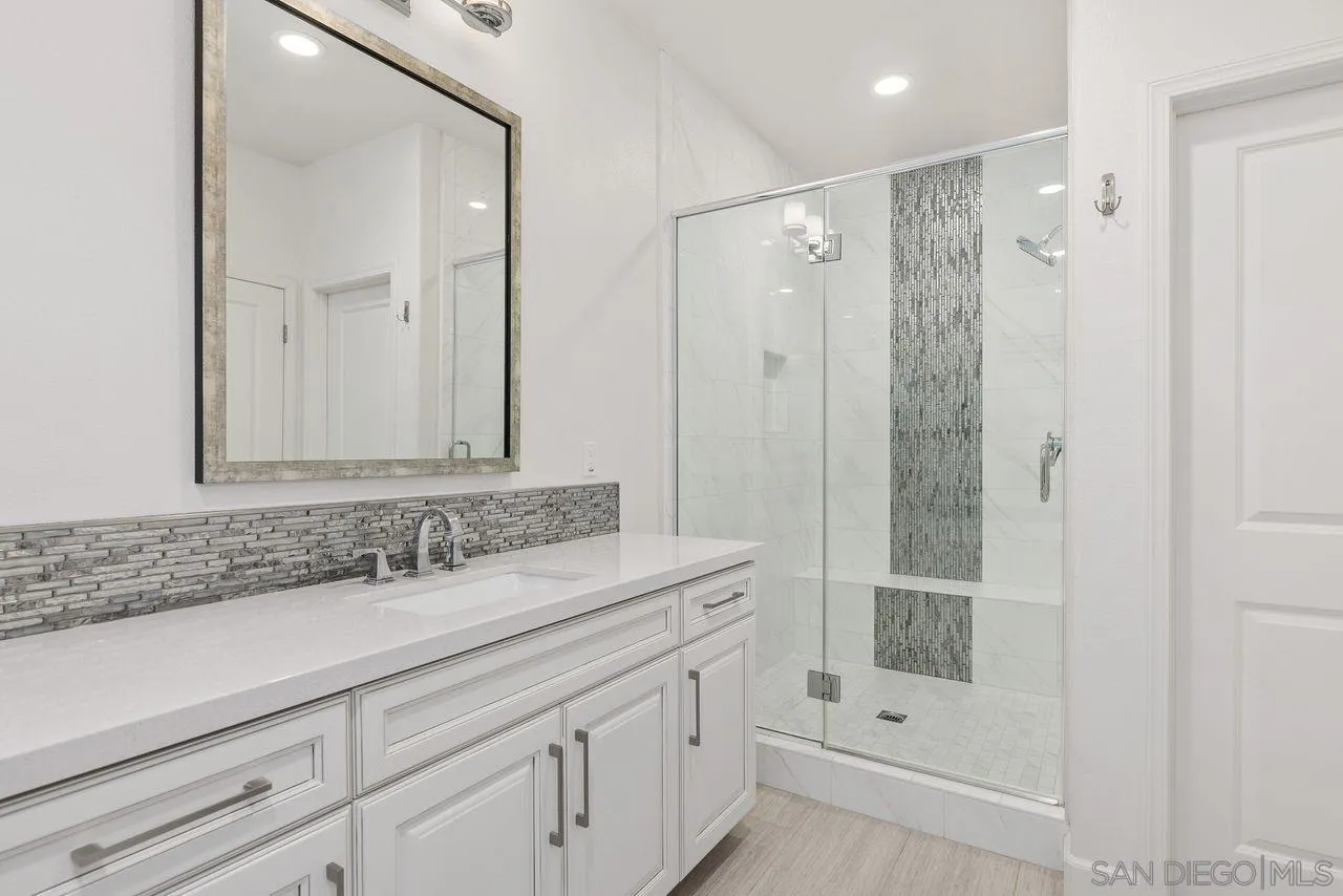13509 Cielo Ranch Road San Diego, CA 92130 - Photo 33 of 54 a bathroom with a shower sink and mirror
