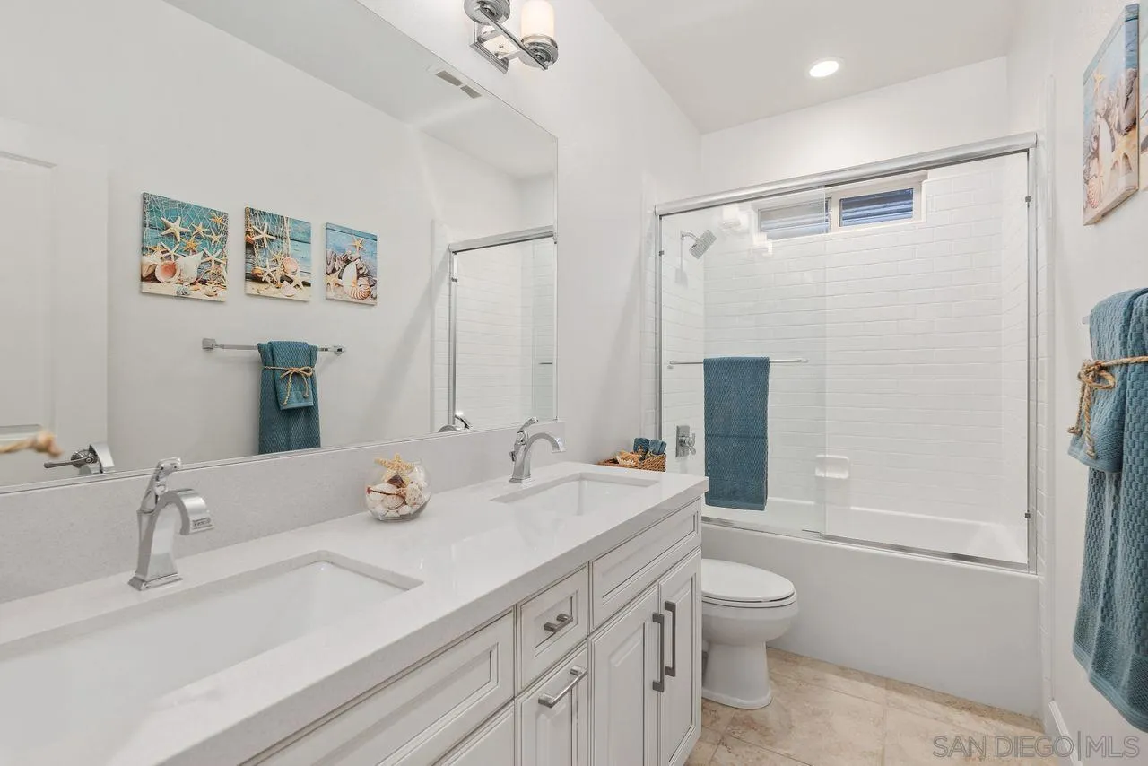 13509 Cielo Ranch Road San Diego, CA 92130 - Photo 35 of 54 a bathroom with a double vanity sink toilet mirror and shower