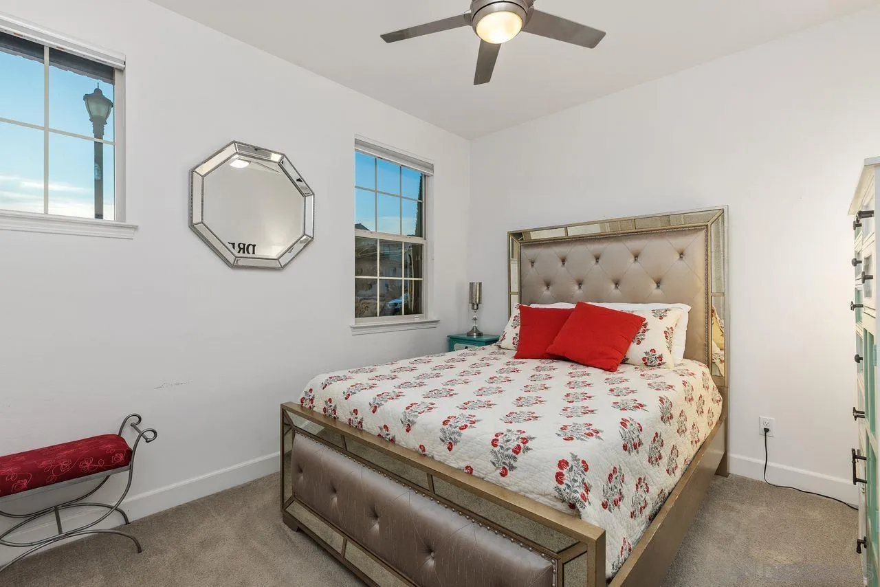 13509 Cielo Ranch Road San Diego, CA 92130 - Photo 37 of 54 a bedroom with a bed and a chandelier