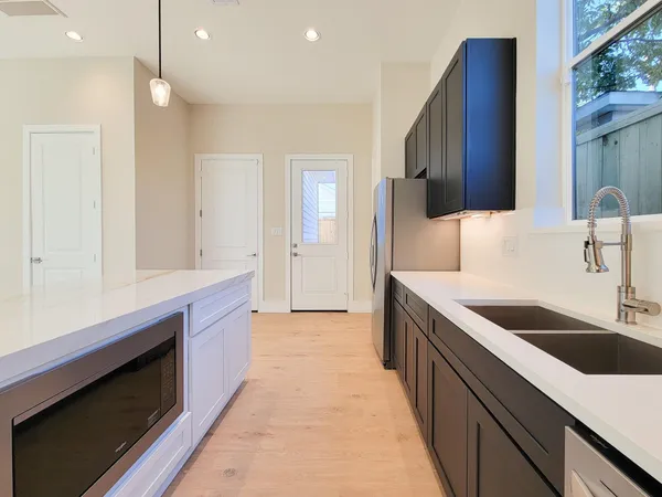 a kitchen with stainless steel appliances granite countertop a sink and a stove
